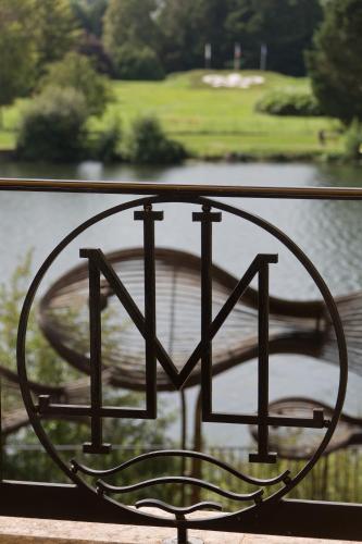 a metal heart shaped sign in front of a body of water at La Côte Saint Jacques in Joigny