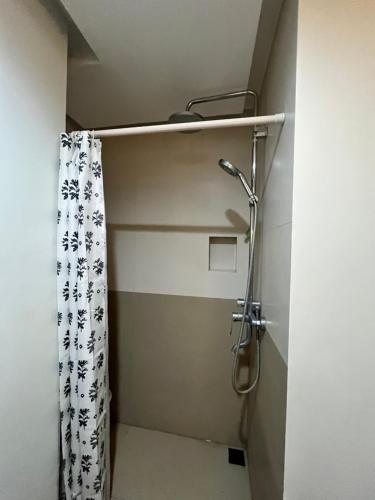a shower in a bathroom with a shower curtain at Appleone Ayala Condo with Balcony in Cebu City