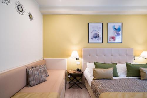 a living room with a couch and a bed at Hotel Rivage Taormina in Taormina