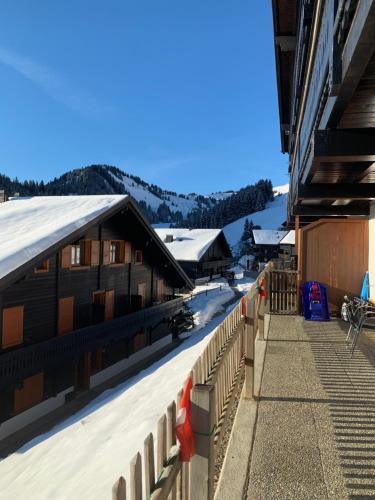 a view of a building with snow on the roof at Les Œillets, Les portes du Soleil in Champoussin
