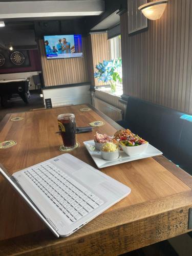 a table with a keyboard and a plate of food at Ye Olde Original Withy Trees in Bamber Bridge