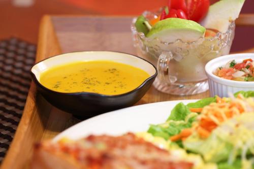 a plate of food with a bowl of soup and salad at Sweet Heart B&B in Jian