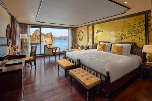 a bedroom with a large bed and a large window at Indochine Premium Halong Bay in Ha Long