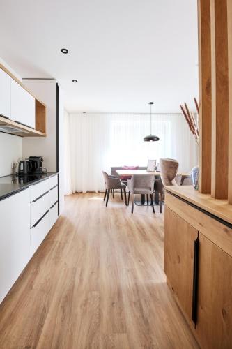 a kitchen and dining room with a dining table at Alpenstolz Damüls Haus 3 - Stilvoll urlauben in den Bergen in Damuls