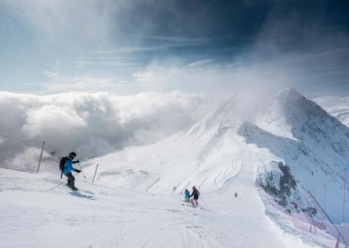 a group of people skiing down a snow covered mountain at Eilander Sunshine in Fiesch
