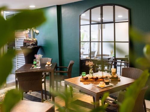 a dining room with two tables with food on it at Novotel Nantes Centre Gare in Nantes