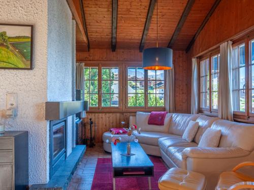 a living room with a couch and a fireplace at Chalet Mustela by Interhome in Nendaz