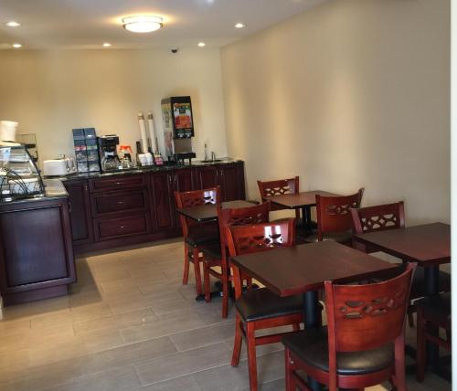 a dining room with wooden tables and chairs at Masterson's Motel in Napanee