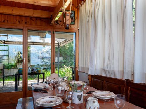 a dining room with a table with plates and glasses at Chalet Valet de Coeur by Interhome in Nendaz