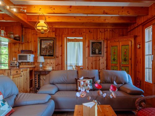 a living room with a couch and a table at Chalet Valet de Coeur by Interhome in Nendaz