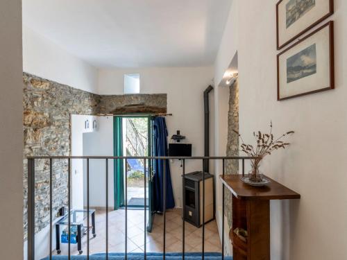 a room with a balcony with a door and a table at Apartment Canneto-3 by Interhome in Stellanello