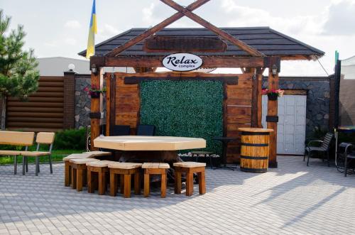 a pavilion with a table and some chairs and tables at RELAX COMPLEX HOTEL in Boryspilʼ