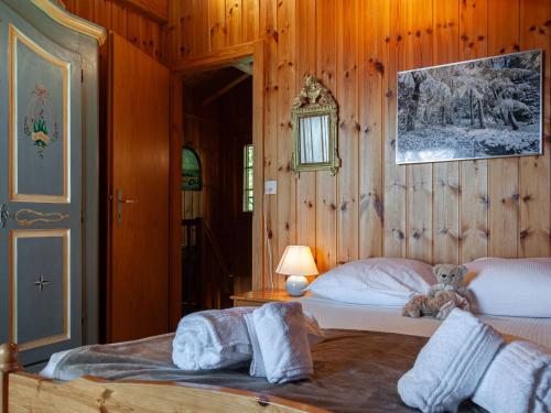 a bedroom with a bed with a teddy bear on it at Chalet Valet de Coeur by Interhome in Nendaz