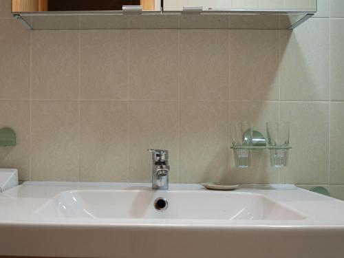a white sink in a bathroom with a mirror at Chalet Valet de Coeur by Interhome in Nendaz