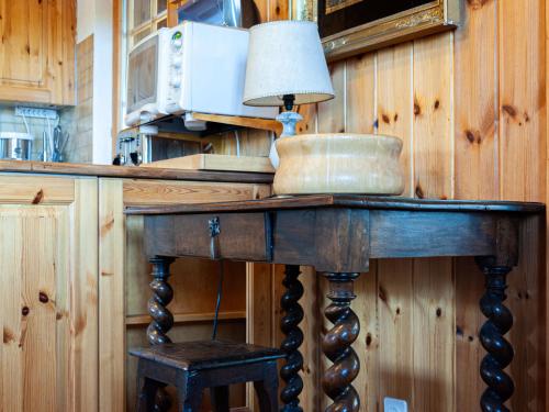 a wooden table with a lamp on top of it at Chalet Valet de Coeur by Interhome in Nendaz