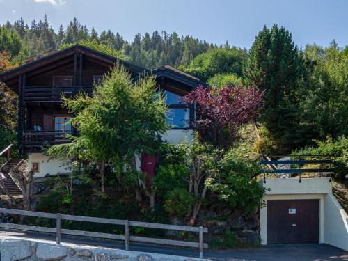 a house on the side of a hill with trees at Chalet Valet de Coeur by Interhome in Nendaz
