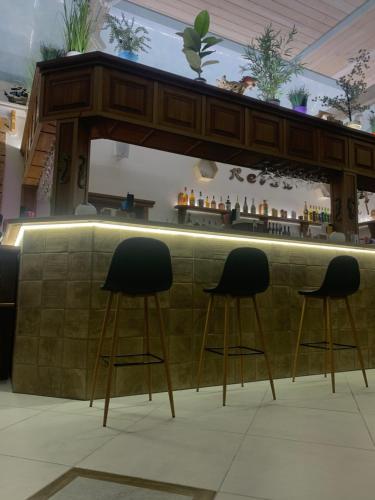 a bar with two stools in front of a counter at RELAX COMPLEX HOTEL in Boryspilʼ