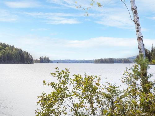 a view of a lake with trees in the background at Chalet Långban by Interhome in Filipstad