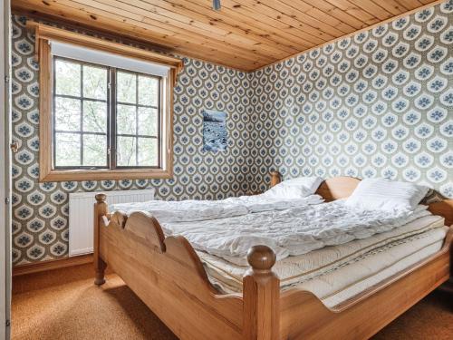 a bedroom with a bed in a room with wallpaper at Chalet Lofsdalen Lavskrikan - HJD030 by Interhome in Lofsdalen
