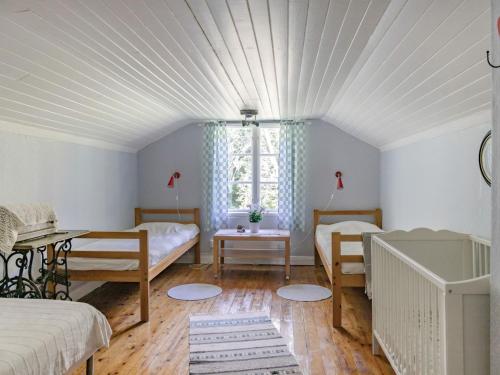 a room with two beds and a window at Holiday Home Bolhyttan by Interhome in Filipstad