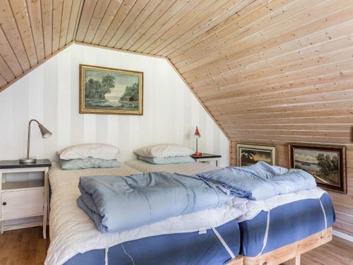 two beds in a room with a wooden ceiling at Holiday Home Västra Näs by Interhome in Sölvesborg