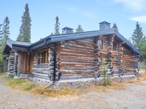 a log cabin with a black roof at Holiday Home Lapinkoto by Interhome in Ruka