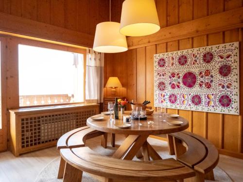 a dining room with a table and a window at Apartment Licorne 13 by Interhome in Verbier