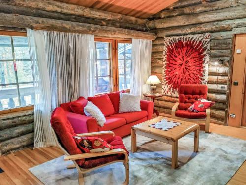 ルカにあるHoliday Home Karhunpesä by Interhomeのリビングルーム(赤いソファ、テーブル付)