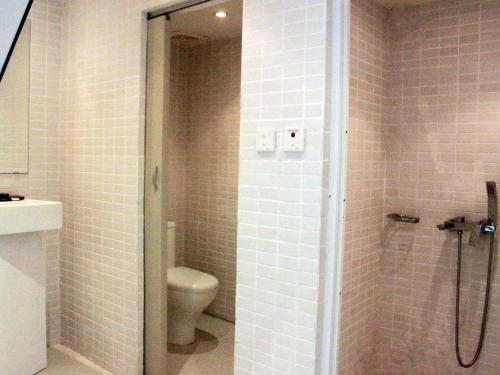 a bathroom with a shower with a toilet and a sink at Thang Long Espana Hotel in Hanoi