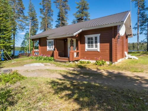 a log home with a yard at Holiday Home Pajulintu by Interhome in Tiitanvaara