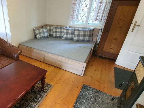 a couch sitting in a living room with a door at Holiday Home Praskolesy by Interhome in Praskolesy