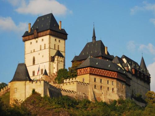 a large castle with two towers on a hill at Holiday Home Praskolesy by Interhome in Praskolesy