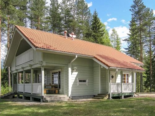 two people standing on the roof of a small house at Holiday Home Yläneuvola niemi by Interhome in Neuvola