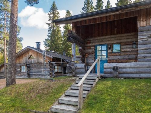 a log cabin with stairs leading to the front door at Holiday Home Vuokatinportti a 11 by Interhome in Lahdenperä