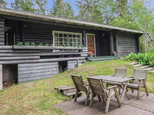 a table and chairs in front of a house at Holiday Home Revonkanta by Interhome in Kauhaniemi