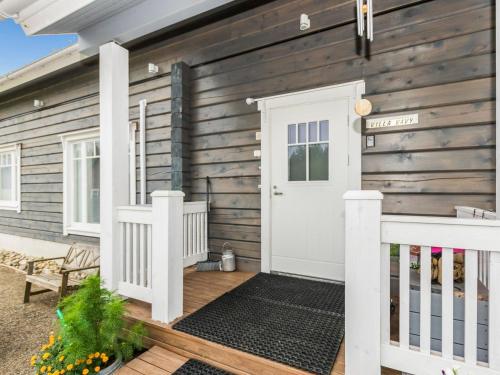 スオネンヨキにあるHoliday Home Suviranta by Interhomeの白い扉とポーチのある木造家屋