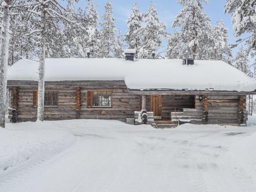 a log cabin with snow on the roof at Holiday Home Lomapata by Interhome in Nissi