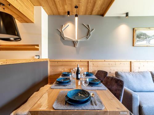 a dining room with a table and a couch at Apartment Les Cimes - Le Lac by Interhome in Tignes