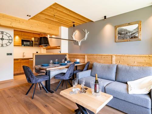 a living room with a couch and a table at Apartment Les Cimes - Le Lac by Interhome in Tignes
