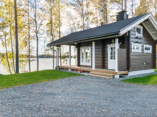 a tiny house on the shore of a lake at Holiday Home Vilpola by Interhome in Majavesi