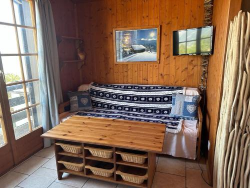 a room with a bed and a table with baskets at Chalet Chalets Tsamandon by Interhome in Nendaz