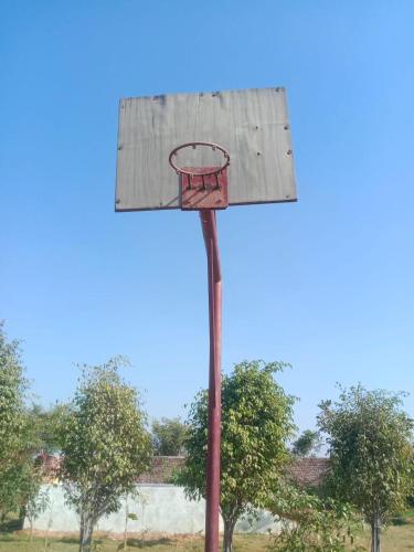 an old basketball hoop with a basketball at Private room in Retreat by Walias Farm Stay in Sohna