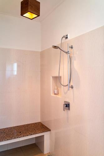 a bathroom with a shower with a glass door at Tropical Hideaway in Beau Vallon