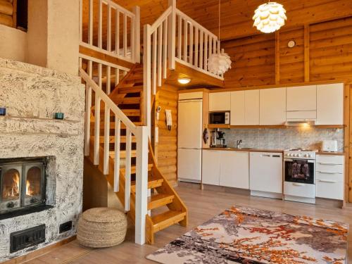 a kitchen and living room with a staircase in a house at Holiday Home Hirsikoto by Interhome in Saariselka