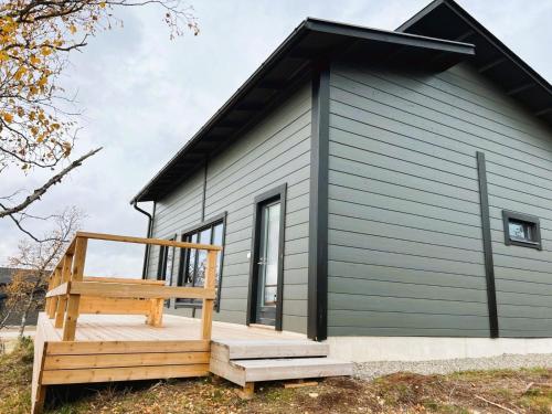 a small house with a deck and a staircase at Holiday Home Villa viima by Interhome in Saariselka