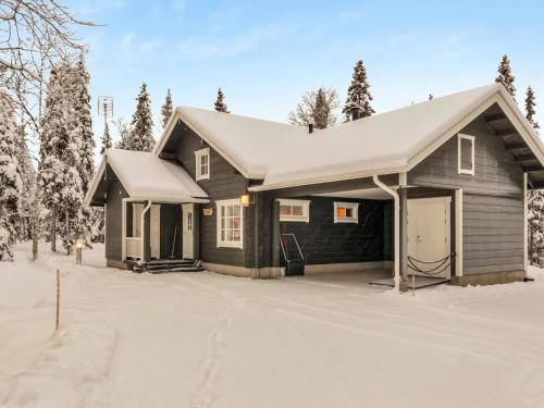 a house in the snow with a garage at Holiday Home Tiera by Interhome in Salla