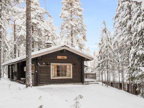 a log cabin in the woods in the snow at Holiday Home Lakka by Interhome in Salla