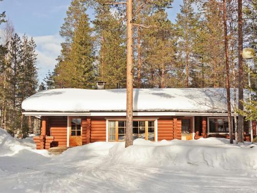 a log cabin in the woods in the snow at Holiday Home Sirkan ojus 1 by Interhome in Sirkka