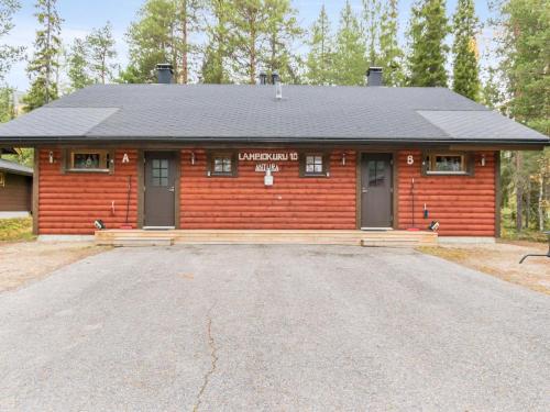 a log cabin with a parking lot in front of it at Holiday Home Antura b by Interhome in Pyhätunturi