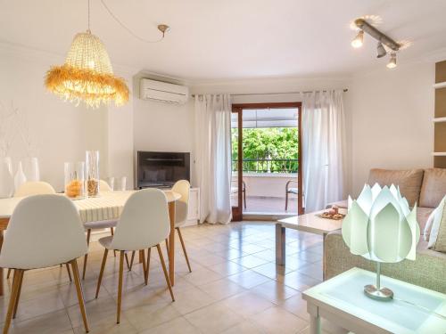 a dining room and living room with a table and chairs at Apartment Nice 4 You by Interhome in Port d'Alcudia
